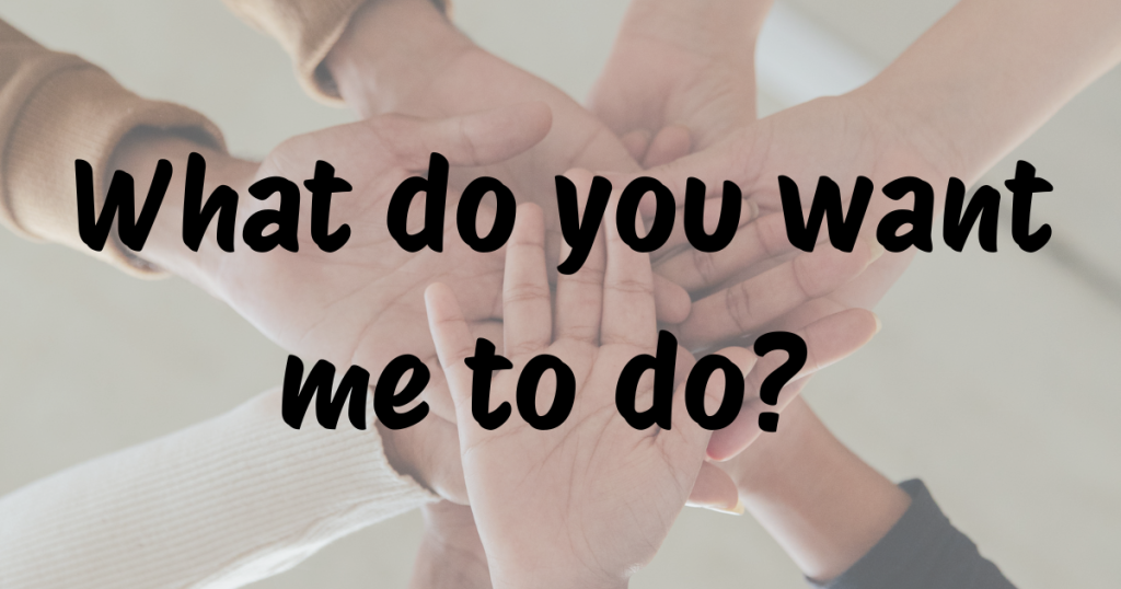 Several hands overlapping in a supportive gesture, with the question “What do you want me to do?” written across the image — illustrating the use of verb + object + infinitive in English grammar.